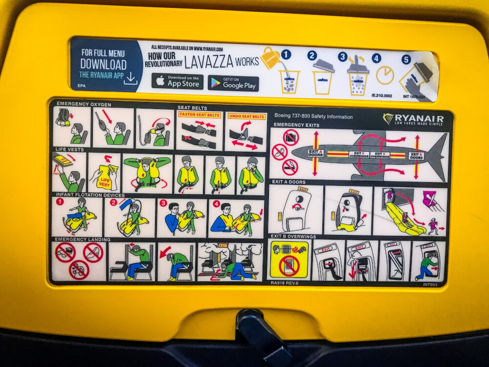 Back of RyanAir seat with safety instructions and an ad