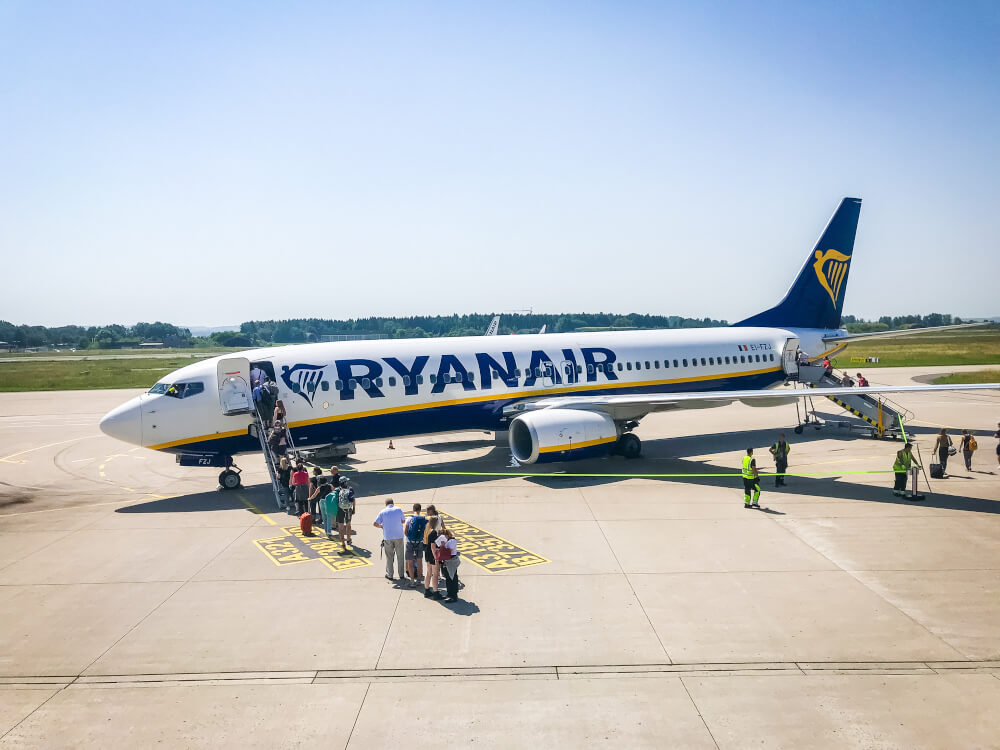 RyanAir plane on the runway with passengers walking on