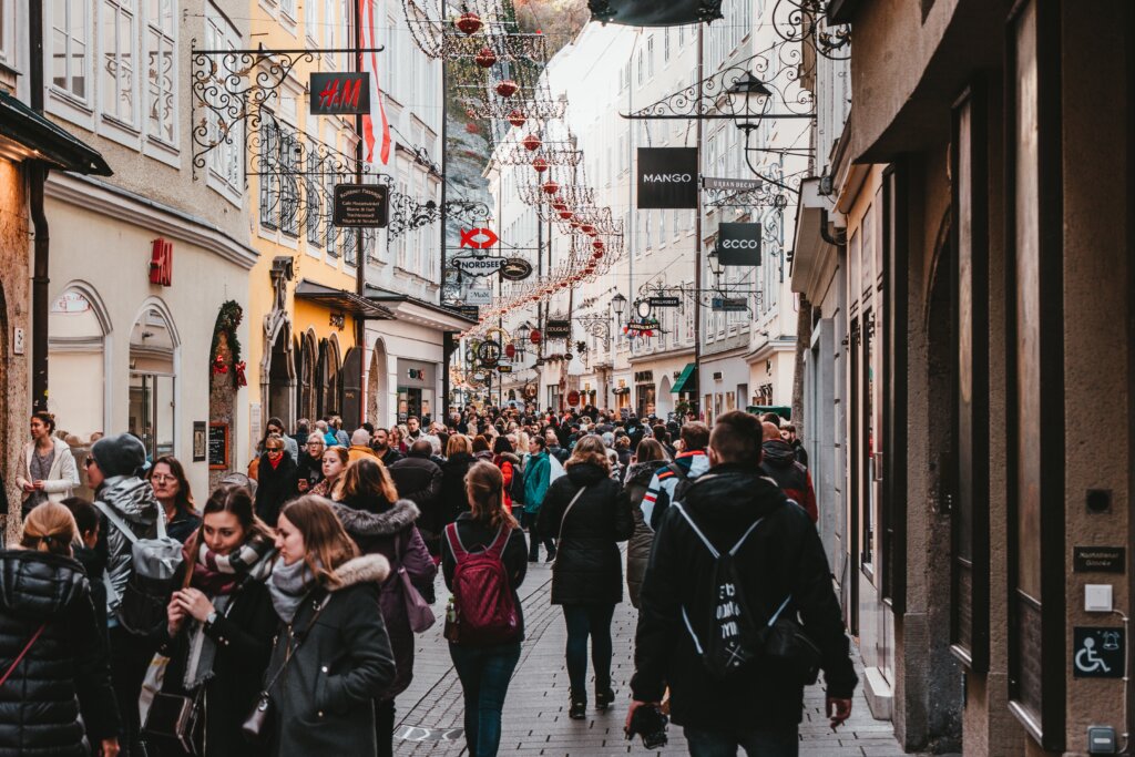 Busy crowds walking through a main shopping street in Salzburg, Austria