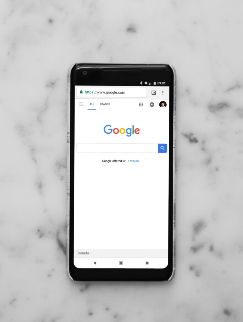 A phone on a table with the Google search page open