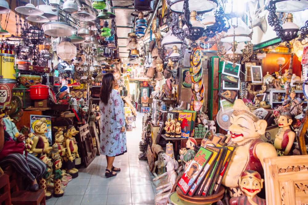 Girl in blue kimono walking through a market in Indonesia