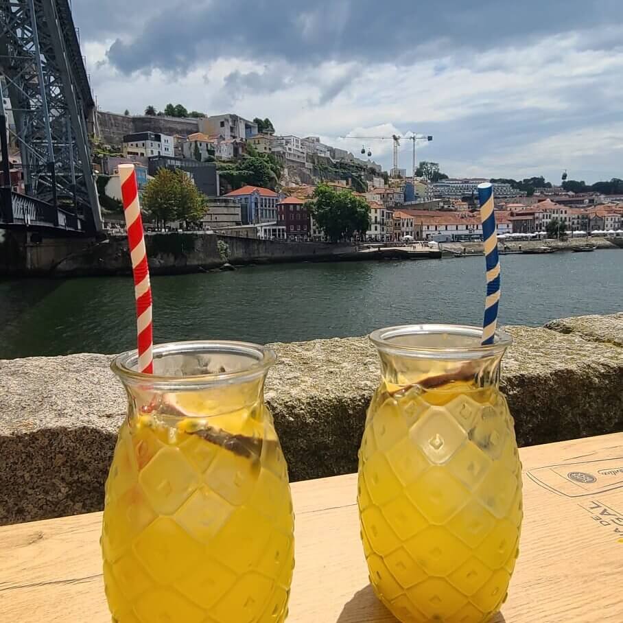 Two glasses of passionfruit sangria in at a riverfront restaurant in Porto