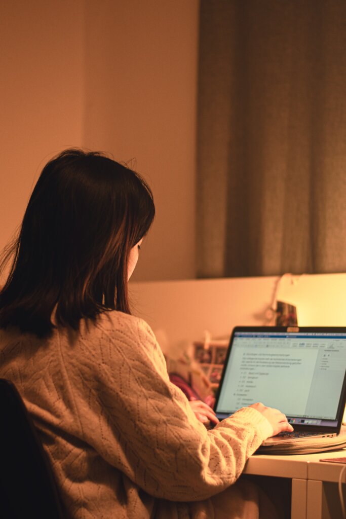 Woman writing on a laptop