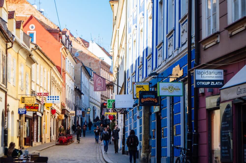 Pedestrians walking on a cobblestoned street in Zagreb, Croatia