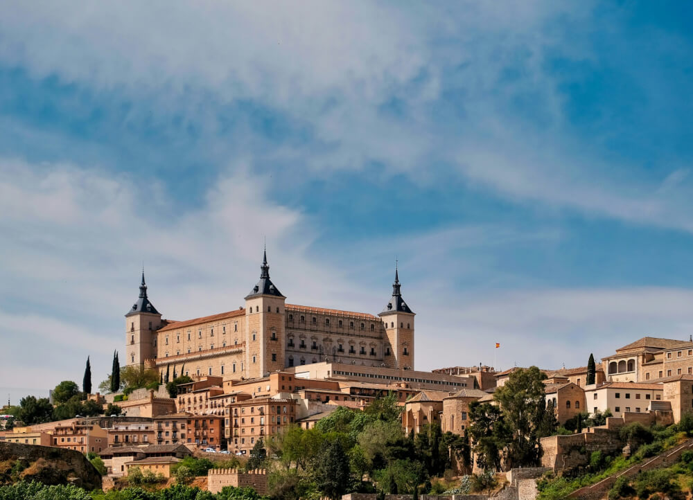 A square castle on a hill with four towers