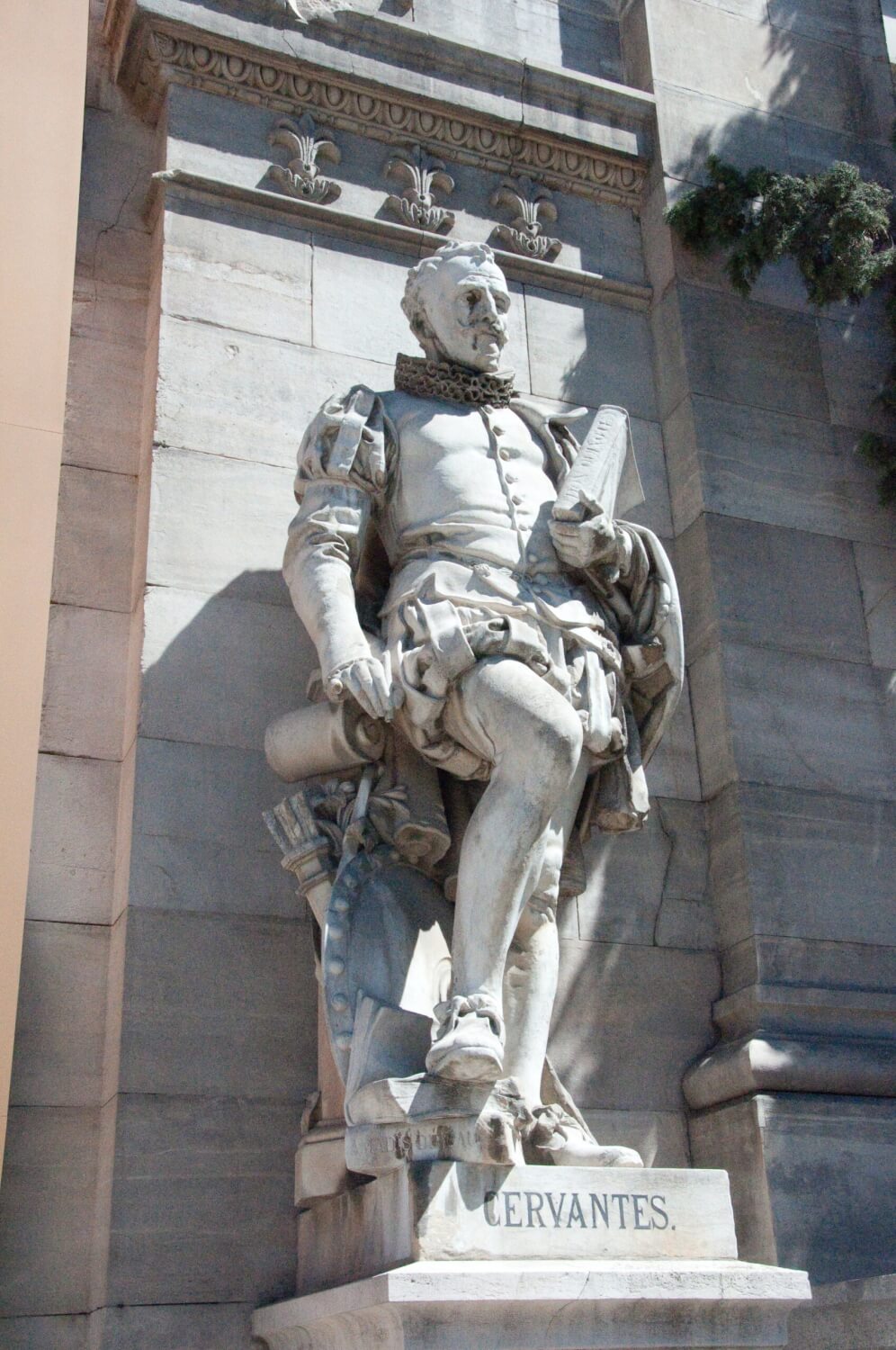 A marble statue of Cervantes.