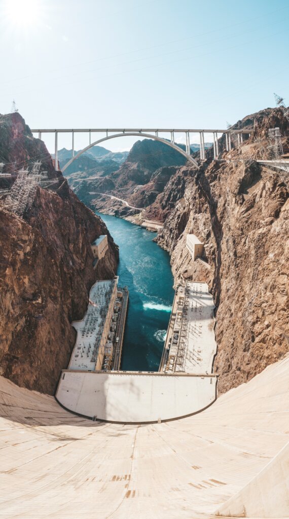 Looking down at the water from the top of hoover dam on a sunny day. 