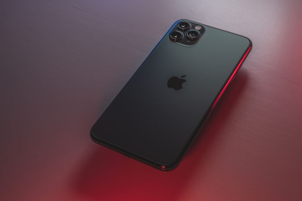 black iphone on a red table