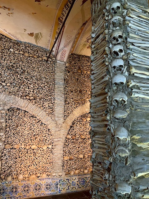A chapel with human bones lined on the wall and decorated into patterns