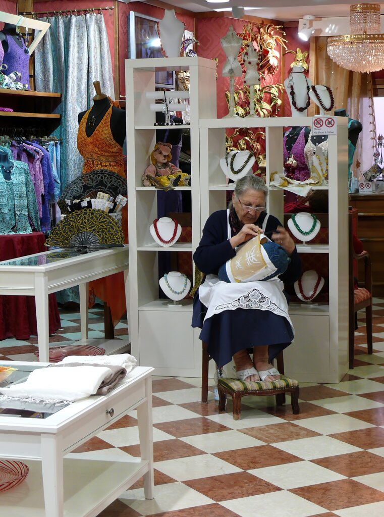 Woman doing lace work in Burano, Italy