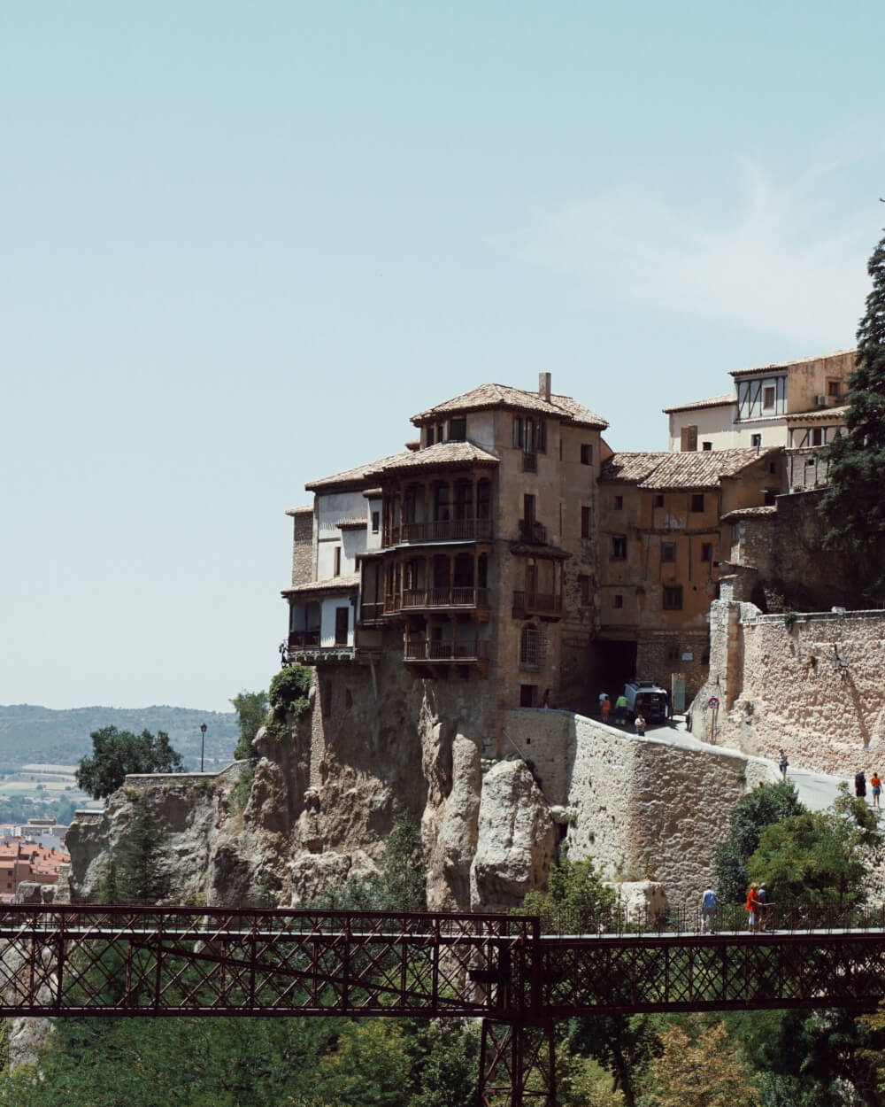 A house is built on the side of a cliff, with the balconies hanging far over the edge. 