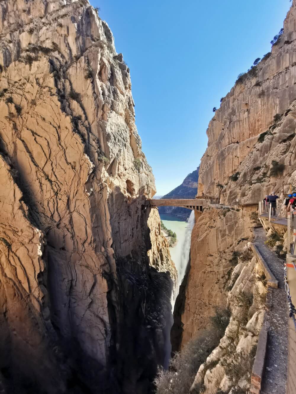 There is a small pedestrian bridge in the middle of a gorge