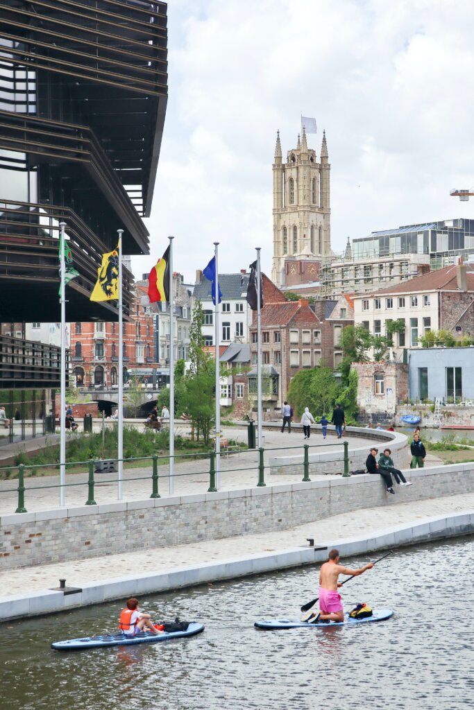 Paddleboarders on the river next to the Krook public library in Ghent