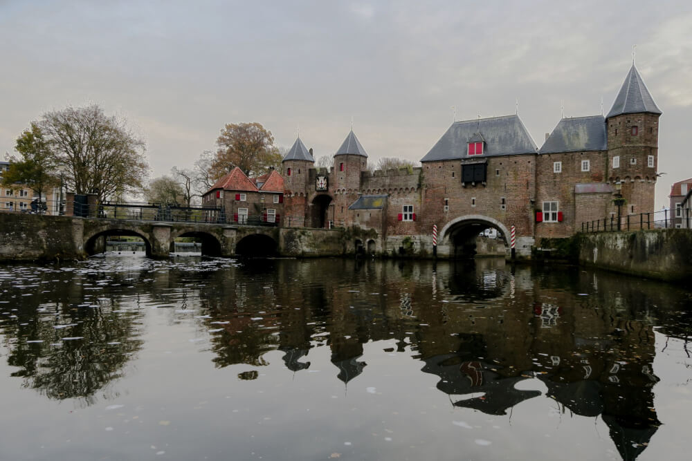 The medieval Koppelpoort Gate of Amersfoort as seen from the water on a grey day.