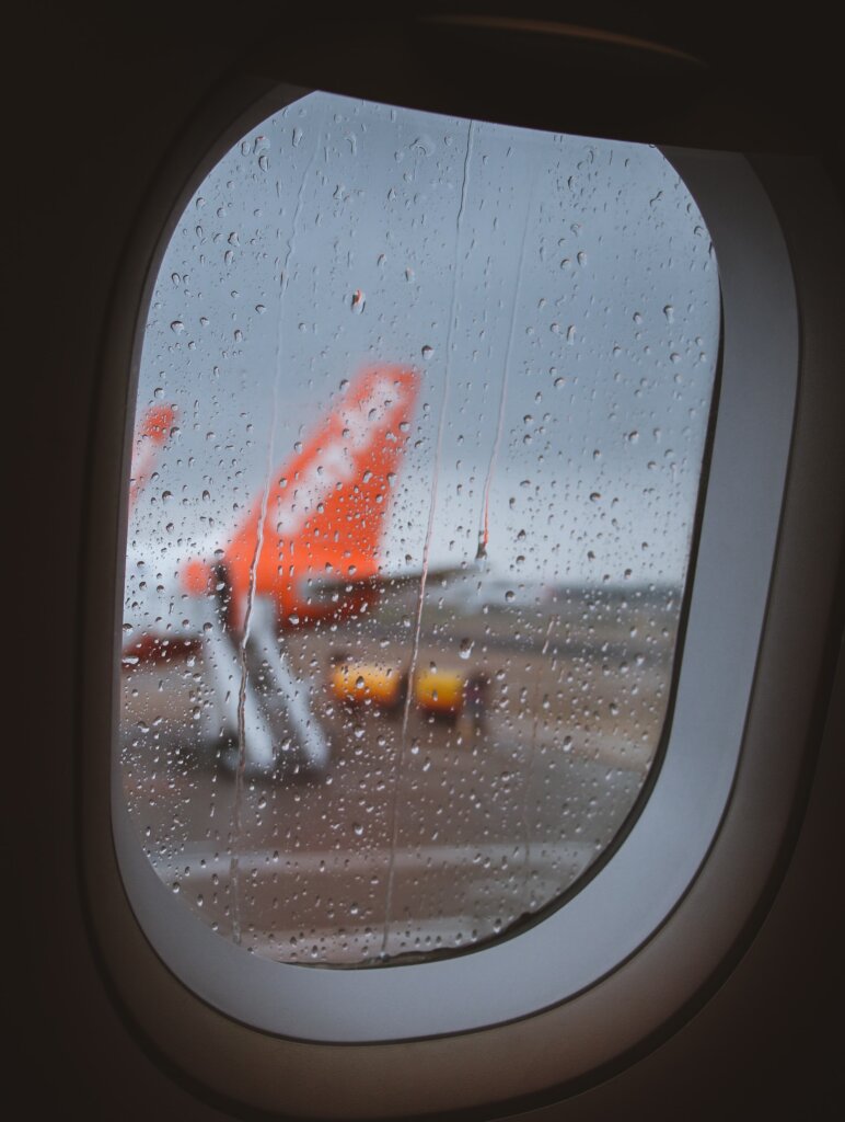 Rainy plane window looking out onto another plane