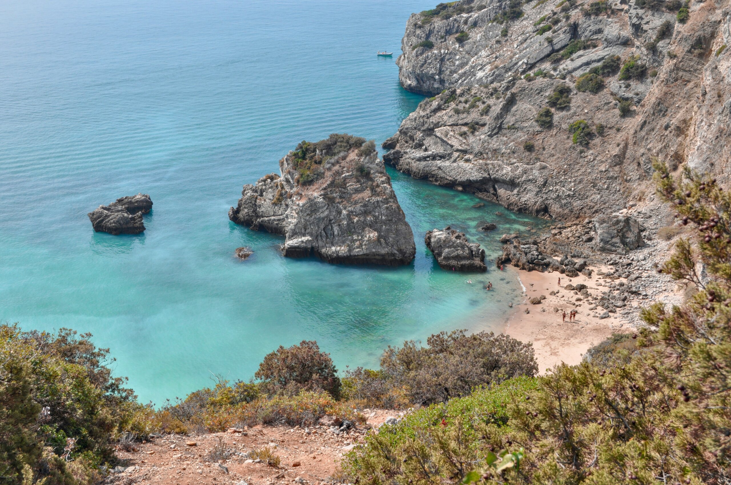 A rocky beach with clear blue-green water