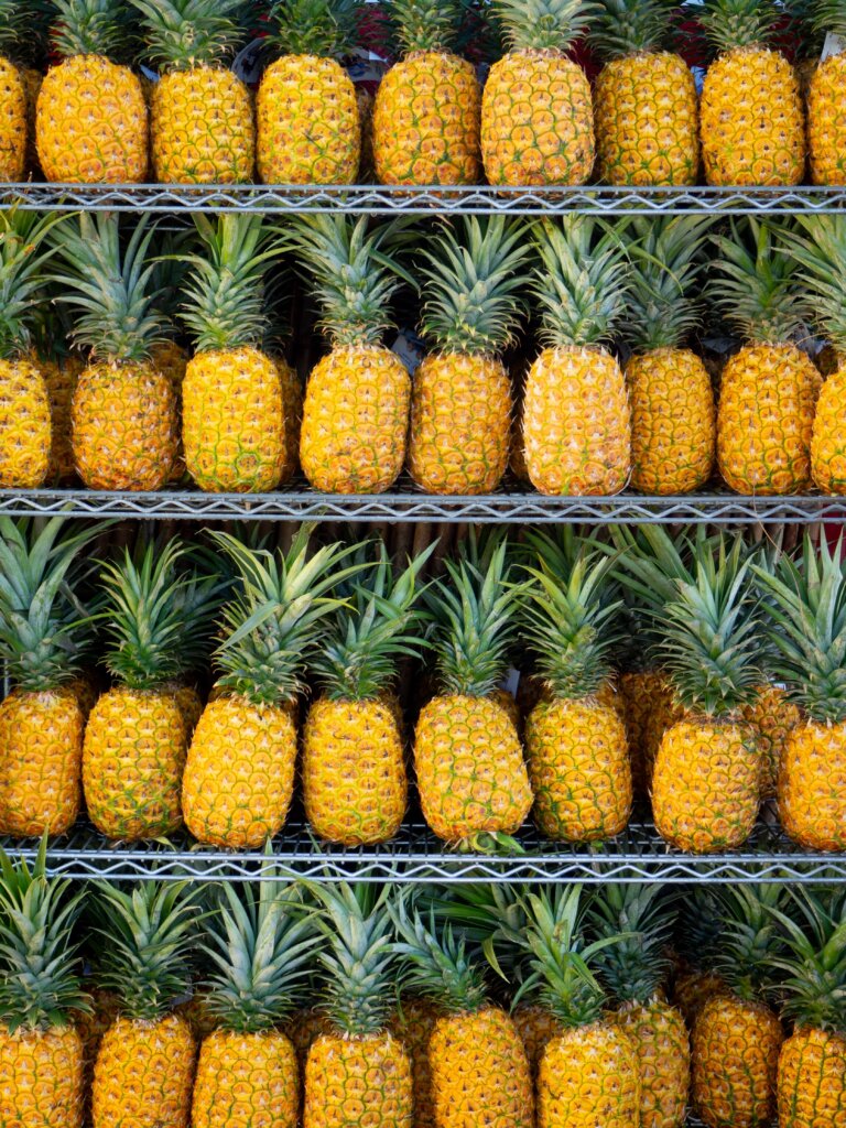 Countless ripe pineapples on shelves, waiting to be bought!