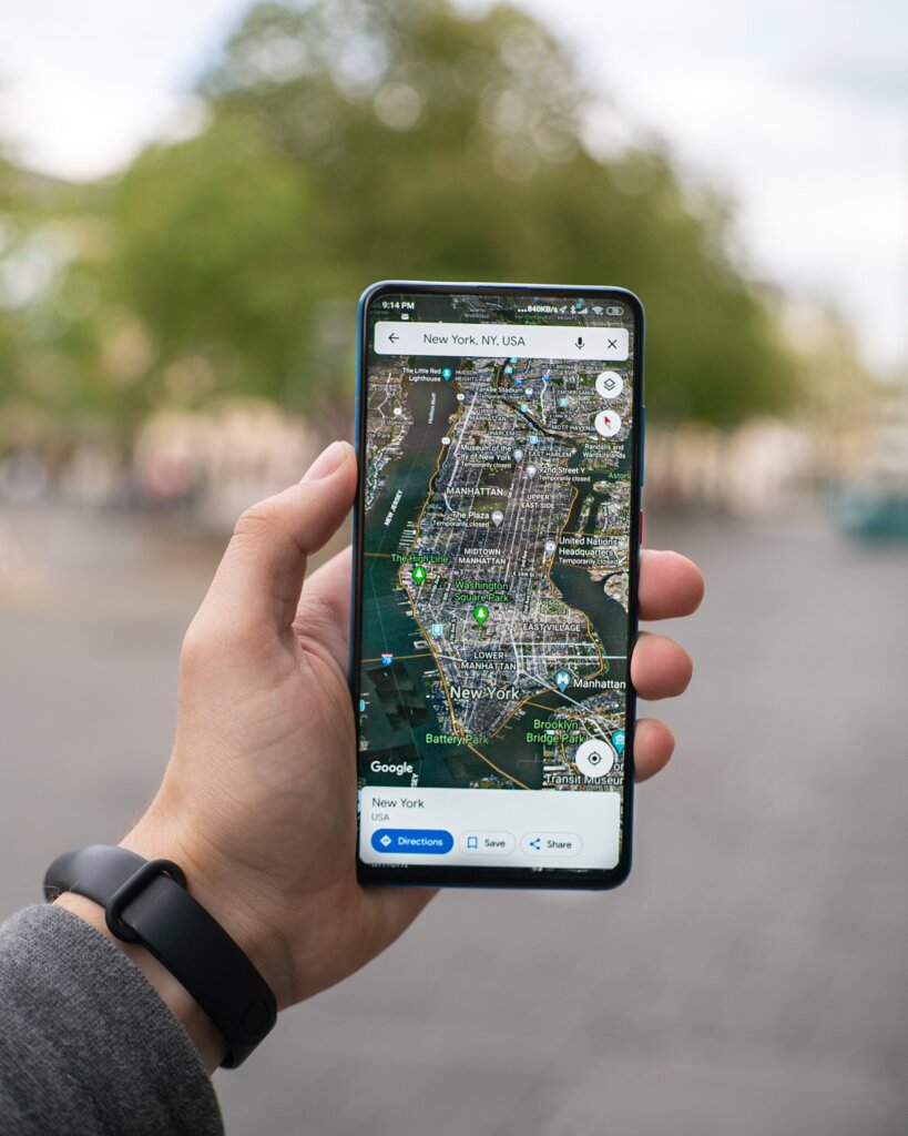 A phone held up showing Google Maps of New York City