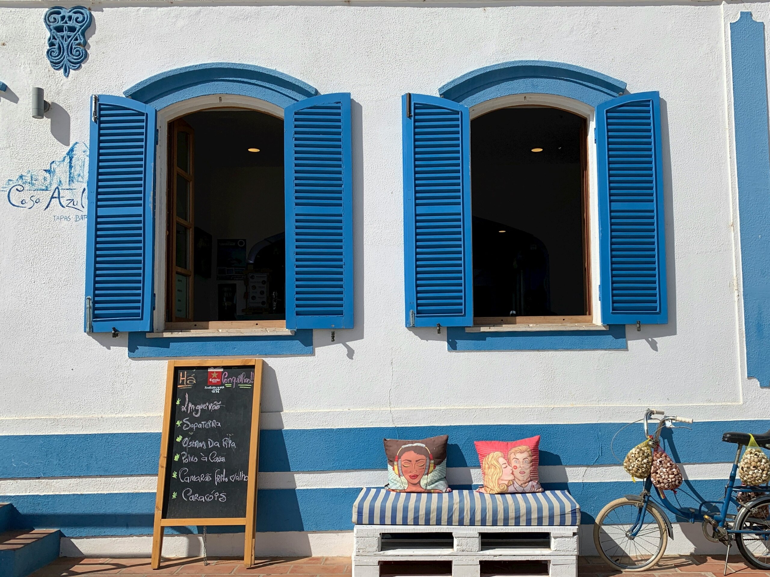 white cafe with blue accents and outdoor seating