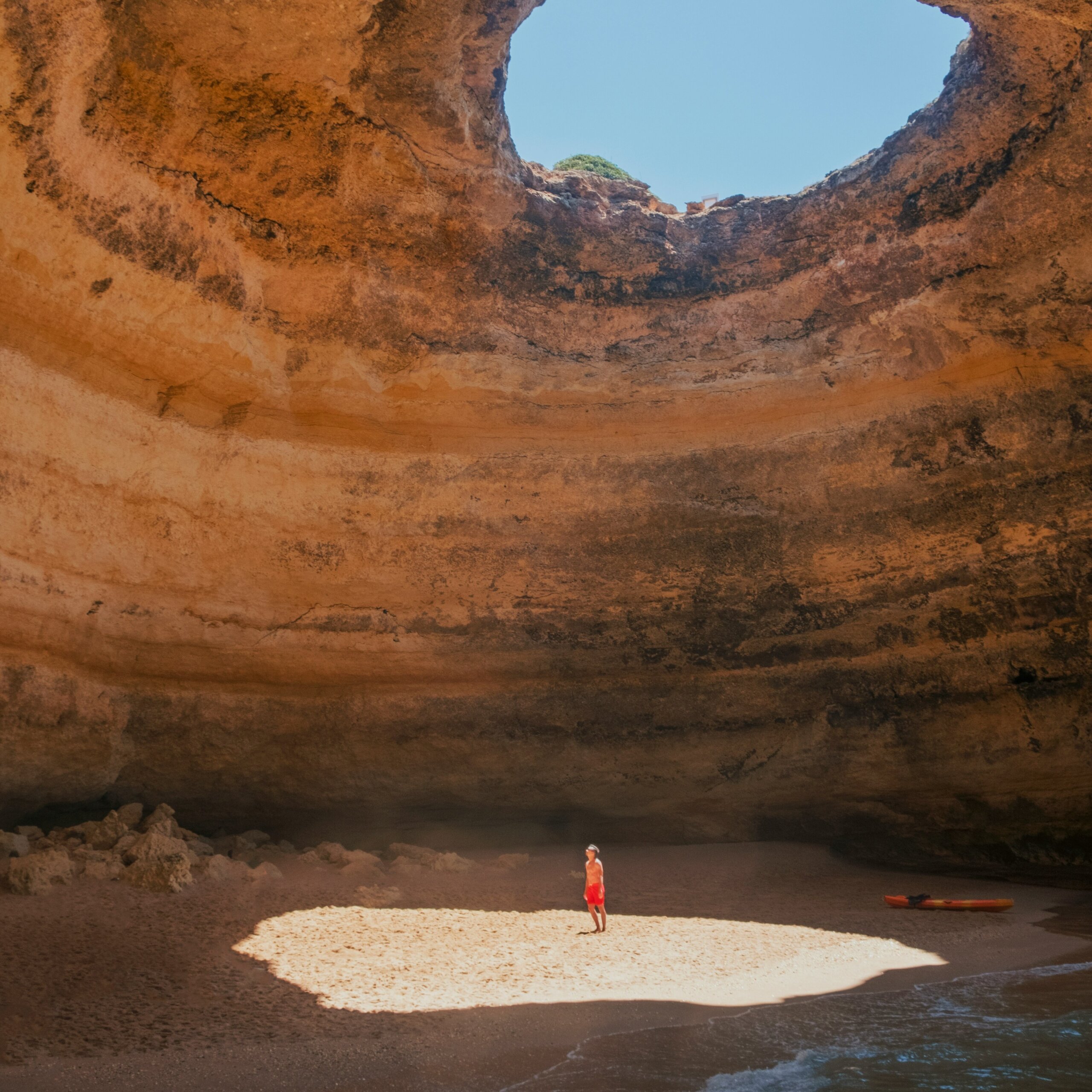 Person standing inside cave