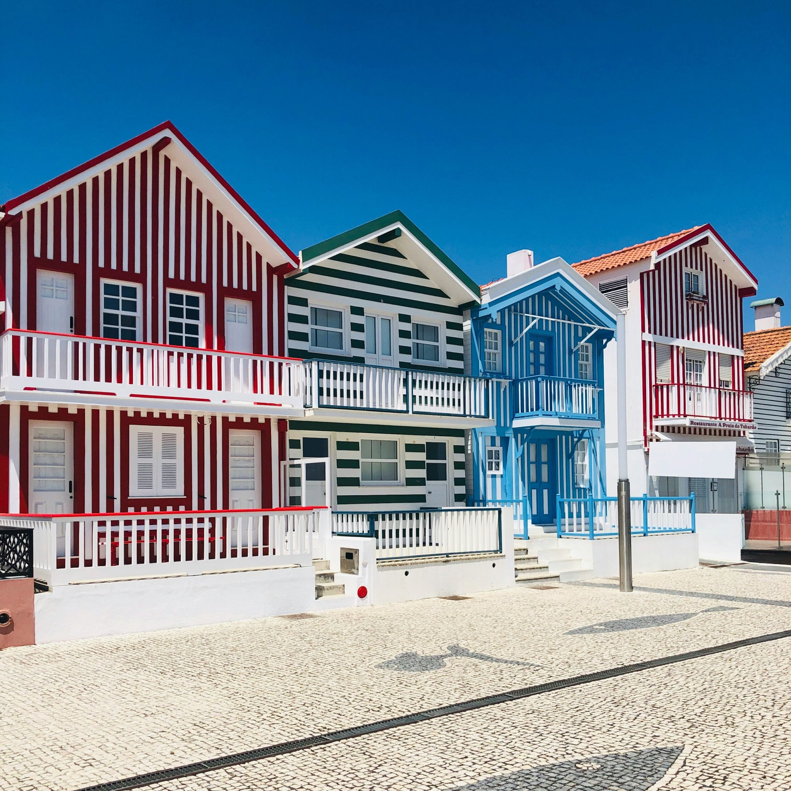 A row of colorful striped houses on a sunny day