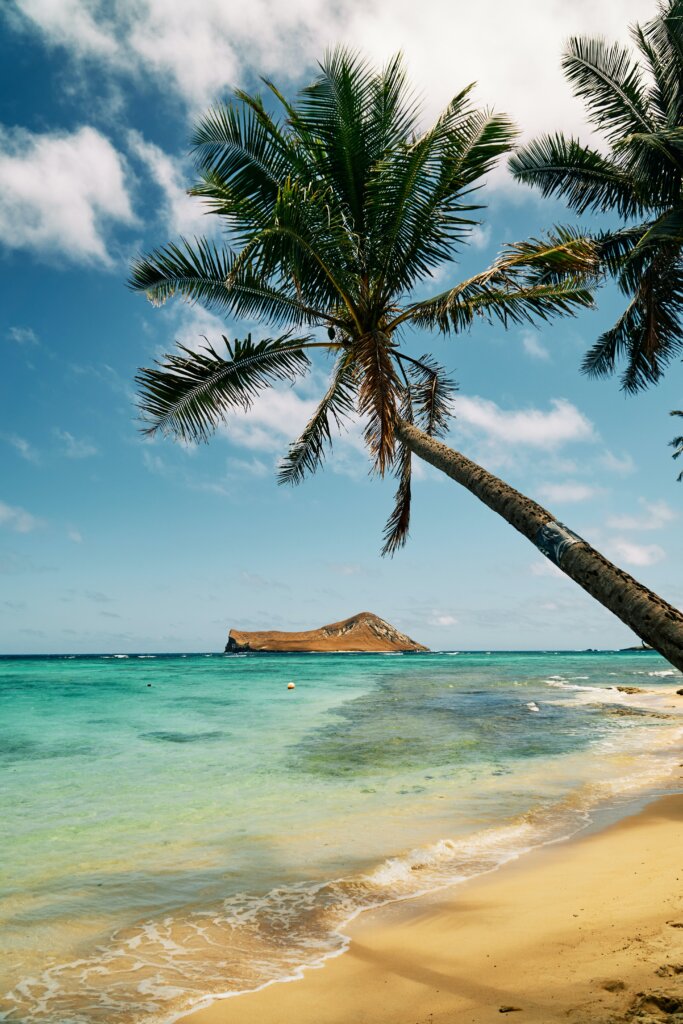 A sunny view of one of many islands in the chain off the beach of another. 