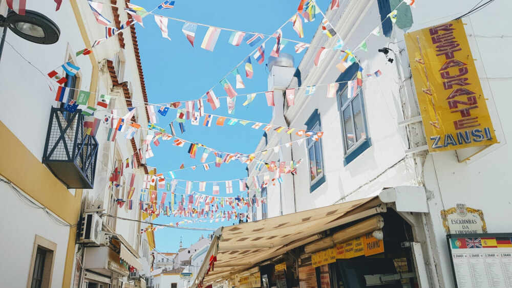 Albufeira street with min-flags lining the alley