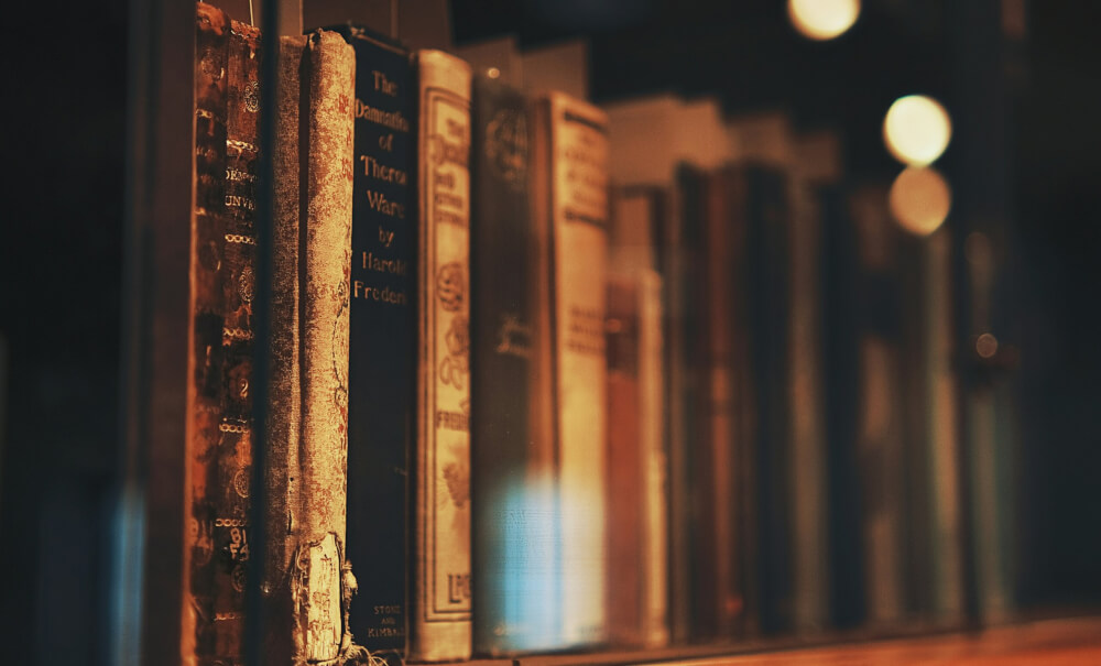 A bookshelf filled with antique books