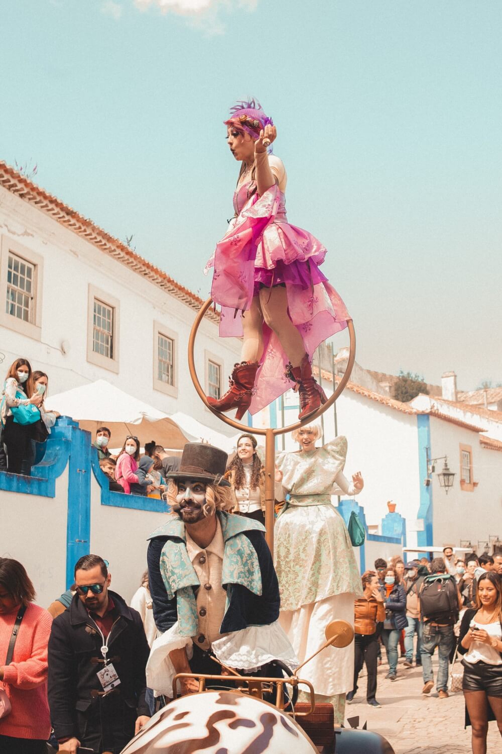 A group of people watching costumed street performers 