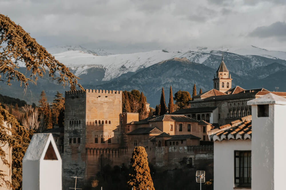 The Alhambra castle with snow-topped mountains in the background