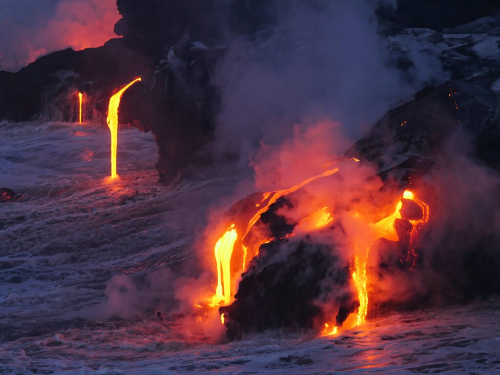 Molted lava running into the ocean at dusk. 