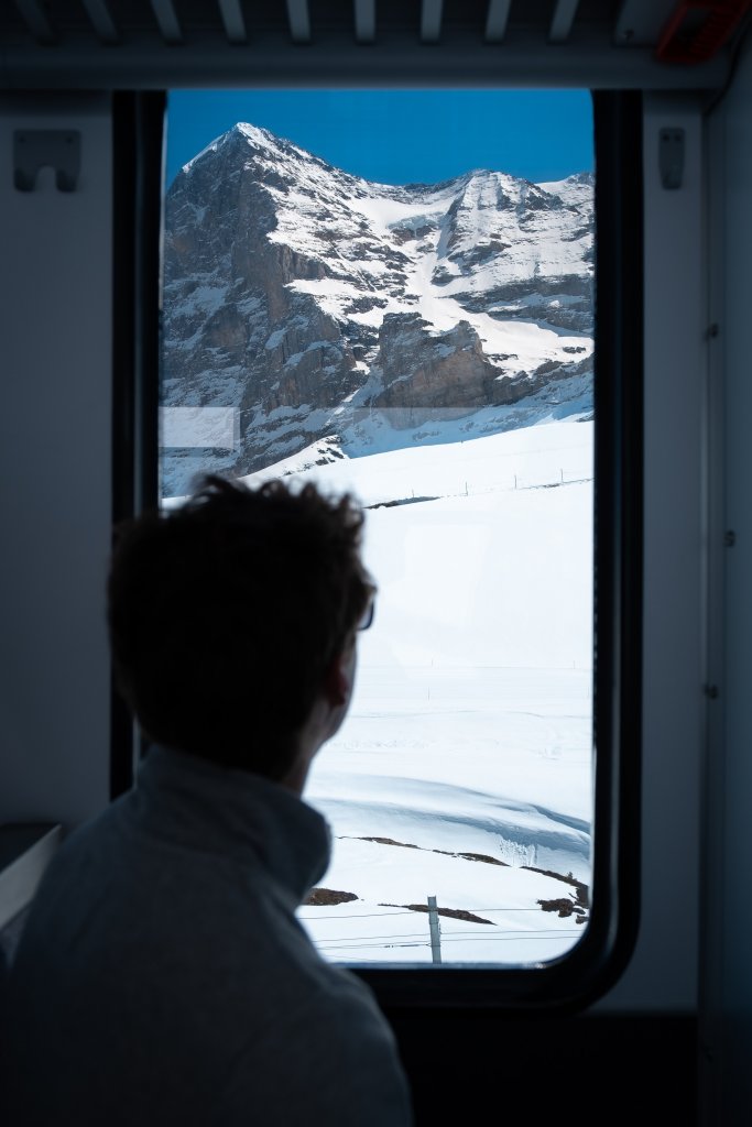 Passenger looking out window on a Swiss train