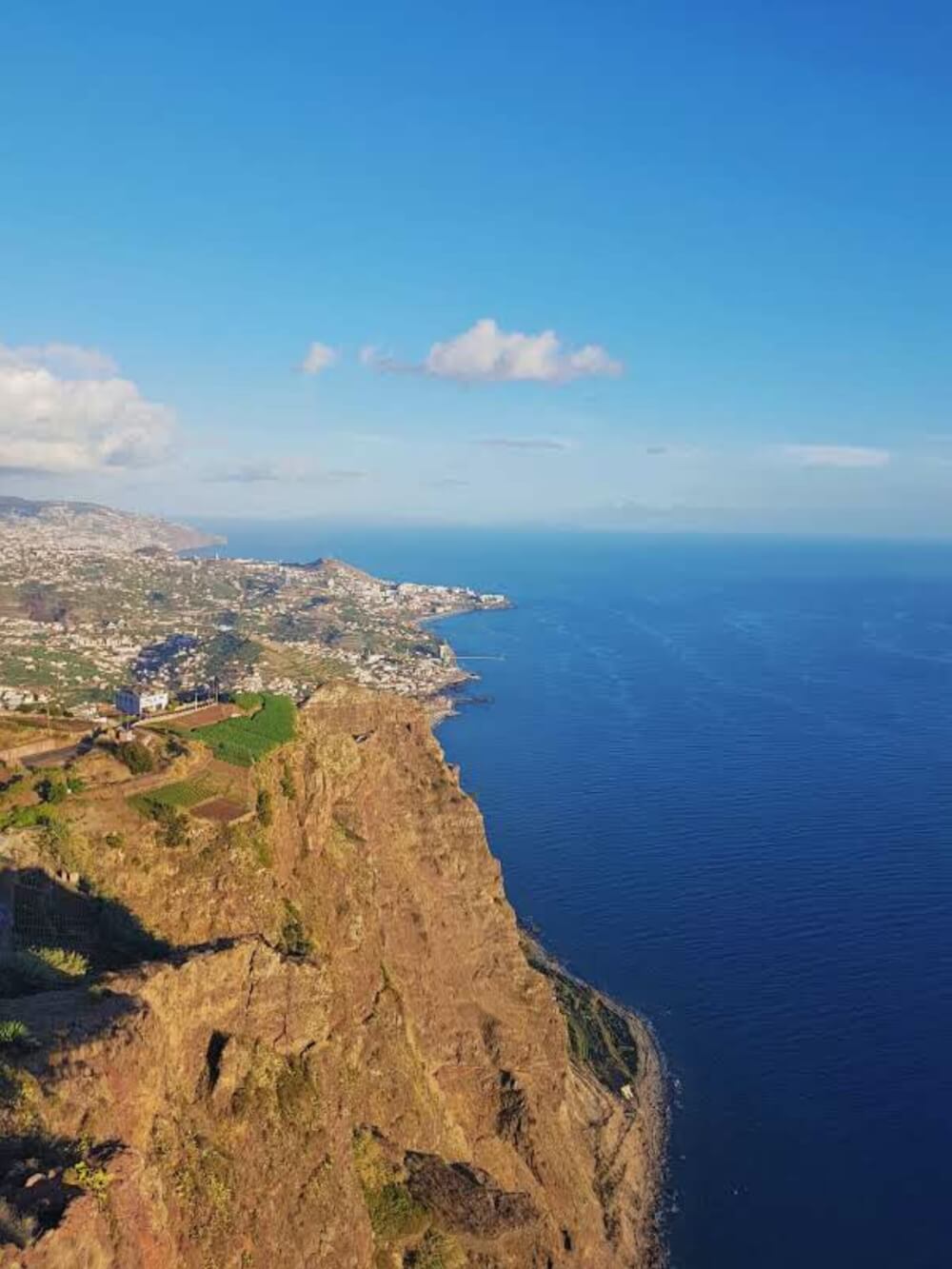 A view of Madeira from above - the Atlantic ocean, mountains, and scattered villages 