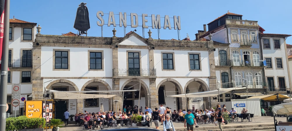 A wine cellar in Porto with the Sandeman logo on top of it.