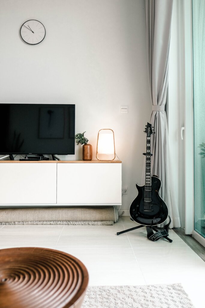 TV and guitar in a nice living space