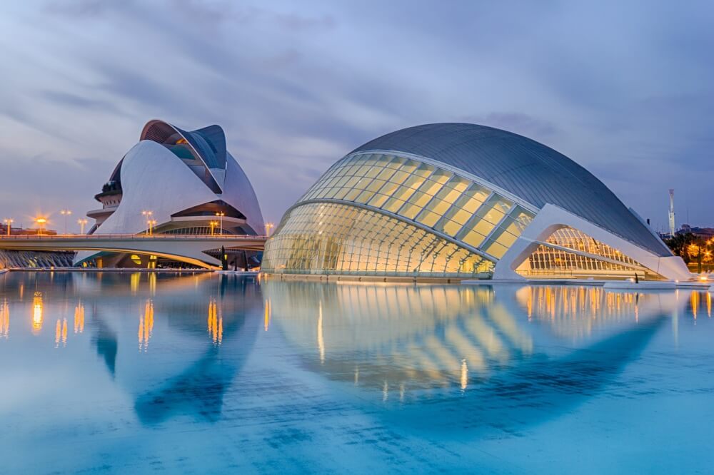 A large modern curved building next to a man made link